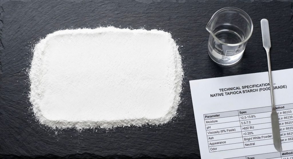 Native tapioca starch powder flat lay with lab equipment and technical spec document for food manufacturers